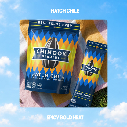 Hatch Chile sunflower seeds in 4 oz and 1.5 oz bags on a striped beach towel
