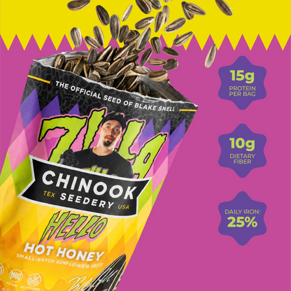 Open 4 oz bag of Hello Hot Honey sunflower seeds with seeds spilling out on a pink background