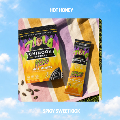 Hello Hot Honey sunflower seeds in 4 oz and 1.5 oz bags on a striped beach towel