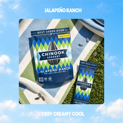 Jalapeño Ranch sunflower seeds in 4 oz and 1.5 oz bags on a striped beach towel